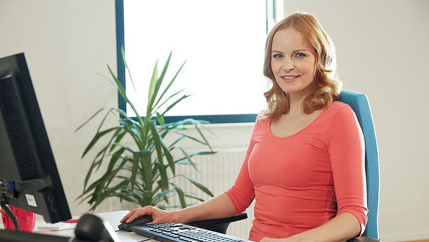 a woman in an ergonomic workplace gets rid of back pain